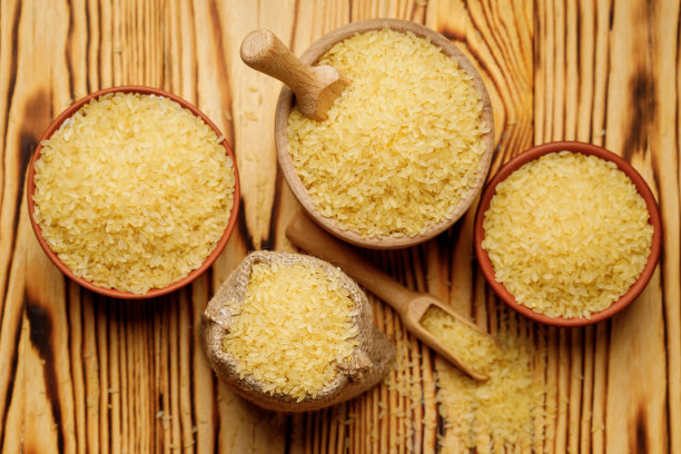 在木制的背景下，用碗和袋子擦亮的米饭。高质量的照片图片下载