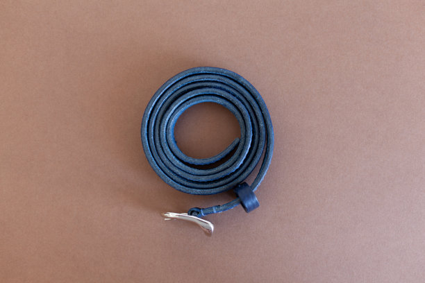 蓝色女人的皮带由真皮，手工制作，躺在一个棕色的背景。俯视图图片下载