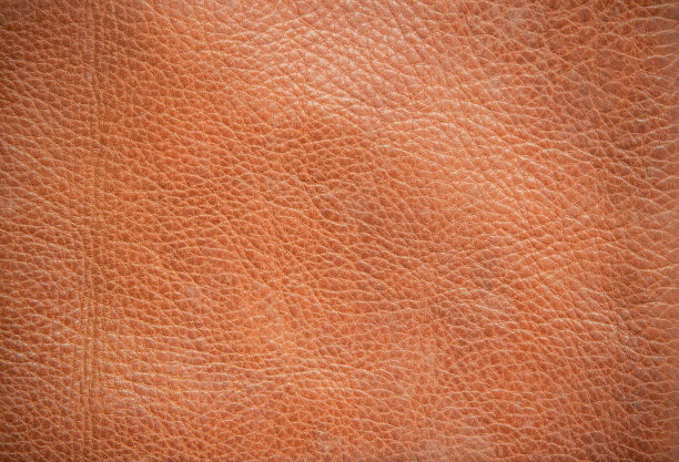 真皮纹理背景。深棕色，橙色纹理为装饰空白。复古皮自然绒面革与设计线条图案或红色抽象可以使用壁纸或背景豪华事件。图片下载