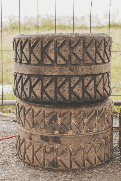 高角度的观点，两个堆叠和肮脏的拉力赛轮胎。图片下载