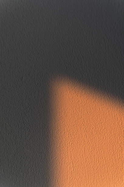 带有阴影和光点的纹理墙。抽象的背景。图片下载