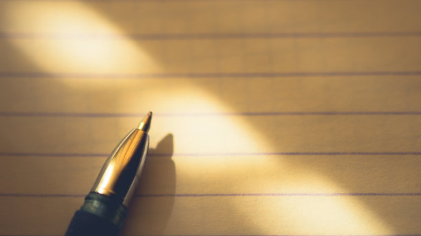 圆珠笔在笔记本纸上排成一行，微距照片，放文字的地方。图片下载