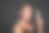 美丽的女人与晒黑的皮肤，拿着一管抗皱平滑抗浮肿眼霜，微笑着看着相机，孤立在黑色的背景与复制广告空间图片下载