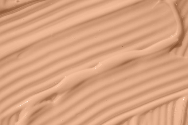 粉底，奶油纹理的底色。米色裸色粉底液质地，遮瑕膏涂抹涂抹滴。特写镜头宏。图片下载