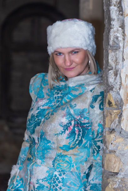 冬天的女王在一座废弃的城堡里。一个穿着冬装的漂亮女人图片下载