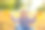 女孩在秋天的公园里捧着一束黄叶图片下载