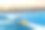 在夏日夕阳的映衬下，池塘的小船上放着一个装满水的儿童水桶和一些玩具图片下载