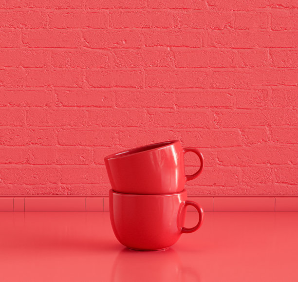一个红色的咖啡杯叠在有砖墙的厨房台面上，没有人图片下载