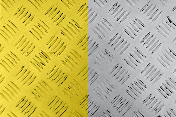 金属表面的缺口在流行的黄色和灰色的颜色。抽象的背景与重复的模式。适合放置文本或设计。图片下载