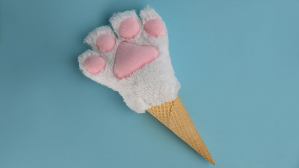 白色毛茸茸的动物爪子放在糖管里。图片下载