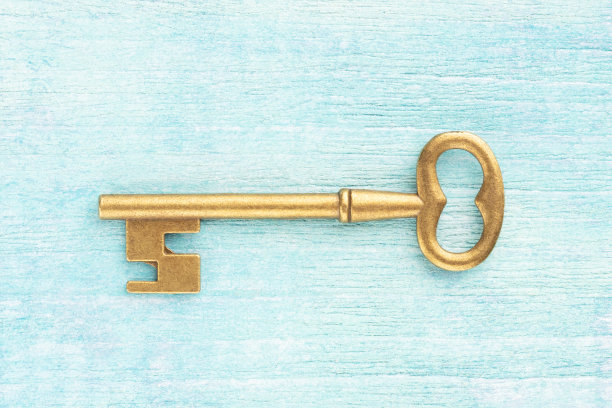 蓝色木制背景上的青铜古董钥匙。古董的概念图片下载