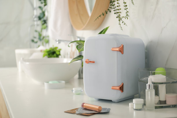 化妆品冰箱和护肤品放在浴室的白色台面图片下载