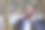 快乐微笑的土耳其男子固定他的黑色夹克，在寒冷的季节(秋、冬、早春)在公园户外，穿着时髦的衣服，自信，手表，现代发型，水平平面图片下载