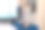 穿着白衬衫的快乐的年轻女子收集或打开箱子里的东西躺在床上。旅游、度假的概念图片下载