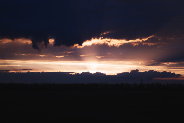 这张照片拍摄的是一个春天傍晚的日落，它穿过城市的阴天。图片下载