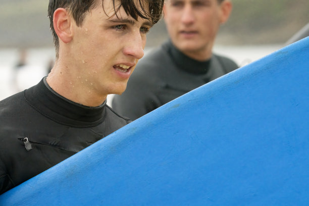 在康沃尔海岸冲浪后离开水面的年轻人图片下载