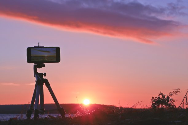 模糊照片-用智能手机拍摄湖面日落的延时。图片下载