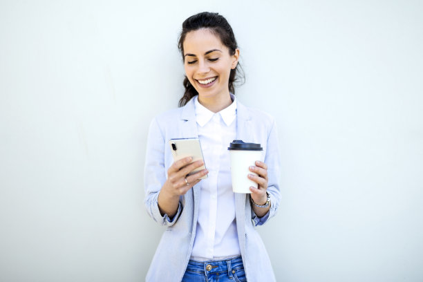 女商人拿着手机和咖啡杯发短信图片下载
