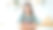 快乐的年轻亚洲女人穿着围裙，站在厨房房间。美丽的女性微笑着看着镜头，感觉很自信素材图片