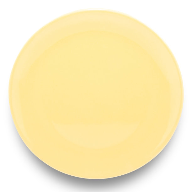 白色背景上孤立的黄色圆形陶瓷板。图片下载
