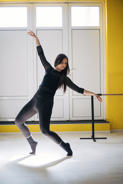 美丽的年轻女子在工作室里跳舞。图片下载