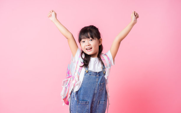 粉红色背景下的亚洲小学生形象图片下载
