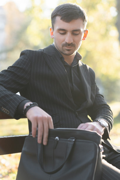 一个商人在他的包里找一份合同图片下载