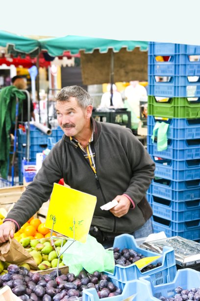农夫在农贸市场出售自家种植的有机农产品图片下载