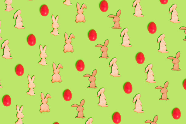 无缝图案的复活节兔子和大胆的粉红色鸡蛋在明亮的绿色背景。最小的充满活力的假日概念。复活节快乐模板或网页横幅的想法。图片下载