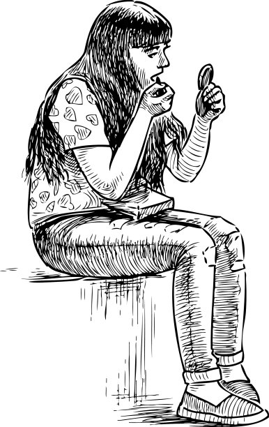 一个小女孩在公园的长椅上化妆图片下载