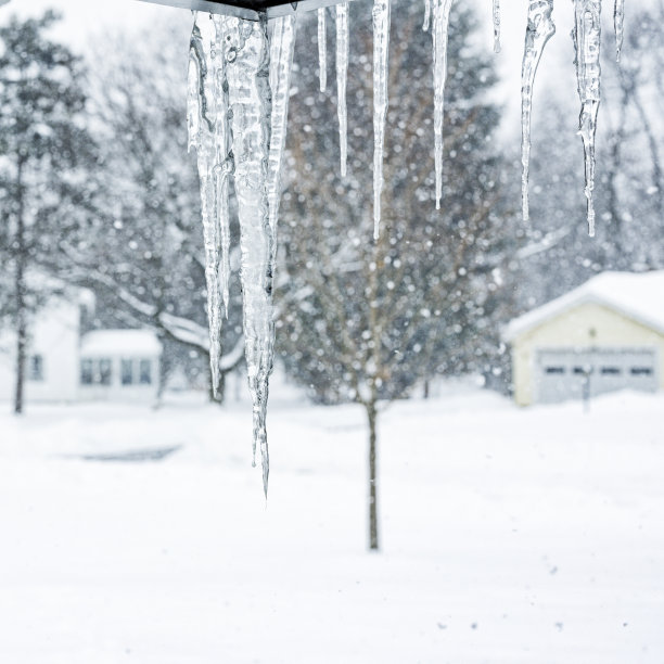 悬挂在屋檐上的冬日冰柱特写图片下载