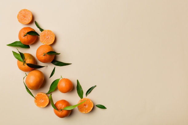 许多新鲜成熟的普通话与绿色叶子彩色背景，俯视图，文字空间图片下载