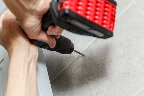 拉派尔曼在墙上钻瓷砖。图片下载