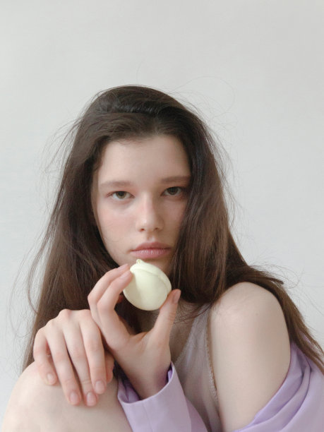 漂亮的年轻女人拿着棉花糖时尚模特吃甜点年轻的亚裔和高加索白人种族工作室拍摄的光背景图片下载