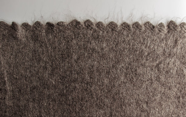 近针织羊毛皮毛纹理。混合绒毛编织线毛衣或围巾作为背景。图片下载