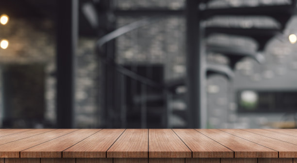 在模糊的餐厅背景上，空的木制桌面与灯光散景。图片下载