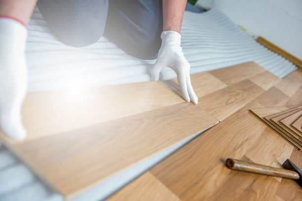 建筑工人在室内从事木地板的铺设、维修和整理工作图片下载