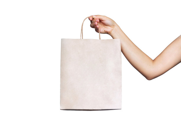 纸环保袋与副本空白的标志在女性手在白色背景孤立图片下载