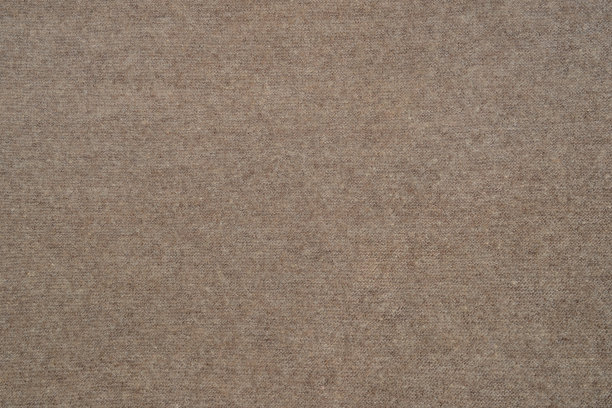摘要以天然毛线手工编织而成的棕色变形背景。温暖舒适的针织衣服或手工格子。用山羊或绵羊的羊毛制成的羽绒披肩图片下载