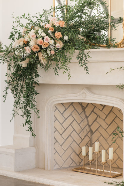 蜡烛在一个别致中立的人字形砖壁炉装饰绿色植物和花卉别致中立，浪漫的乡村现代风格的婚礼接待de林在田纳西州的春天婚礼装饰图片下载