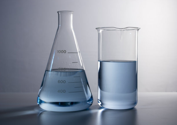 烧杯旁边放着蓝色液体的试管图片下载