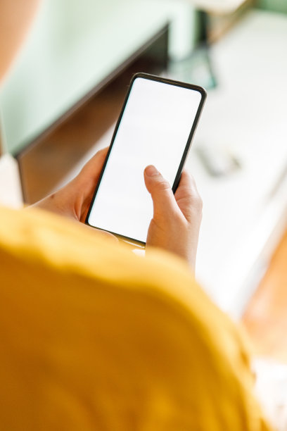 智能手机在女人的手中与空白屏幕，剪出镜头图片下载