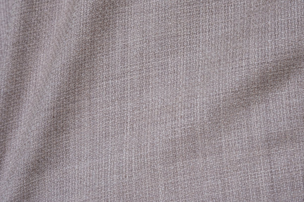 高分辨率细节和高质量拍摄正式棕色米色羊毛西服织物纹理。与前面口袋装饰下的光和阴影环境。理想的背景或墙纸。图片下载