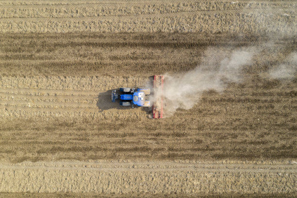 拖拉机和耙在田野上，鸟瞰图图片下载