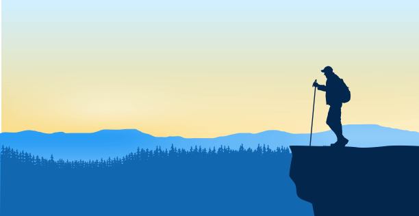 背包游客在悬崖上的剪影图片下载