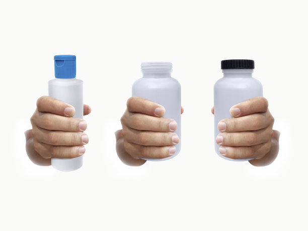 手边的药瓶放在白色背景上图片下载