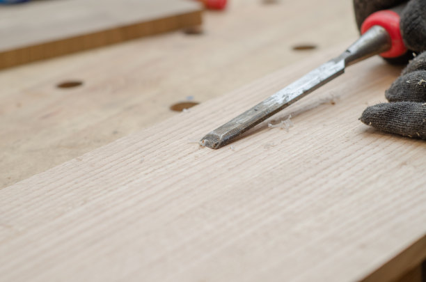 木工用凿子在木板上切槽闭合。图片下载