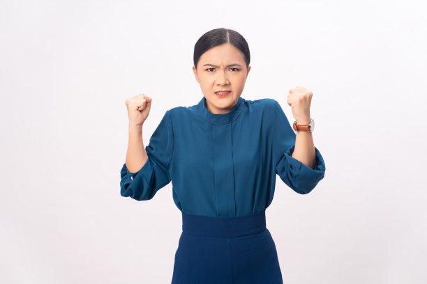 一名亚洲妇女愤怒地站在孤立的背景上。图片下载