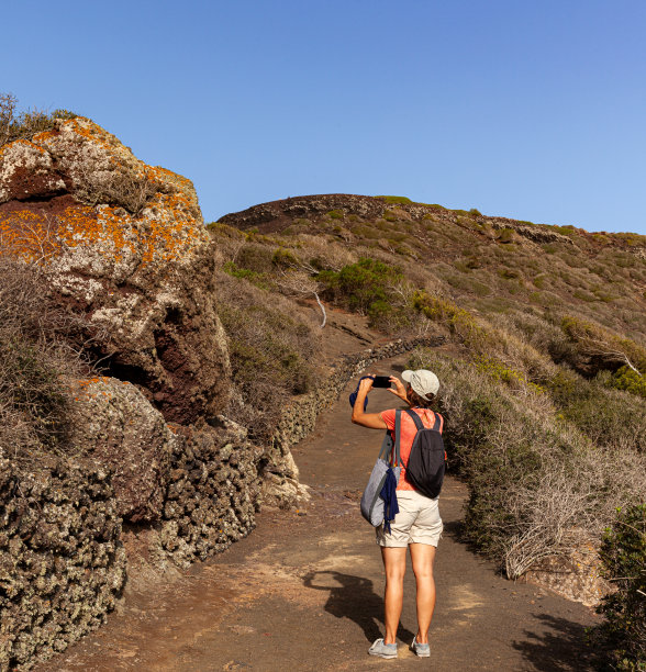 一个女人在拍岩石的照片图片下载