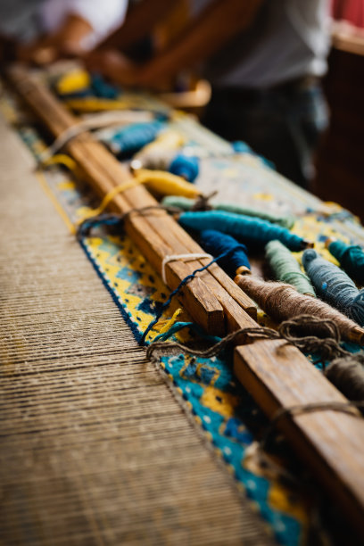 正在制作羊毛地毯的脚踏织布机特写照片图片下载